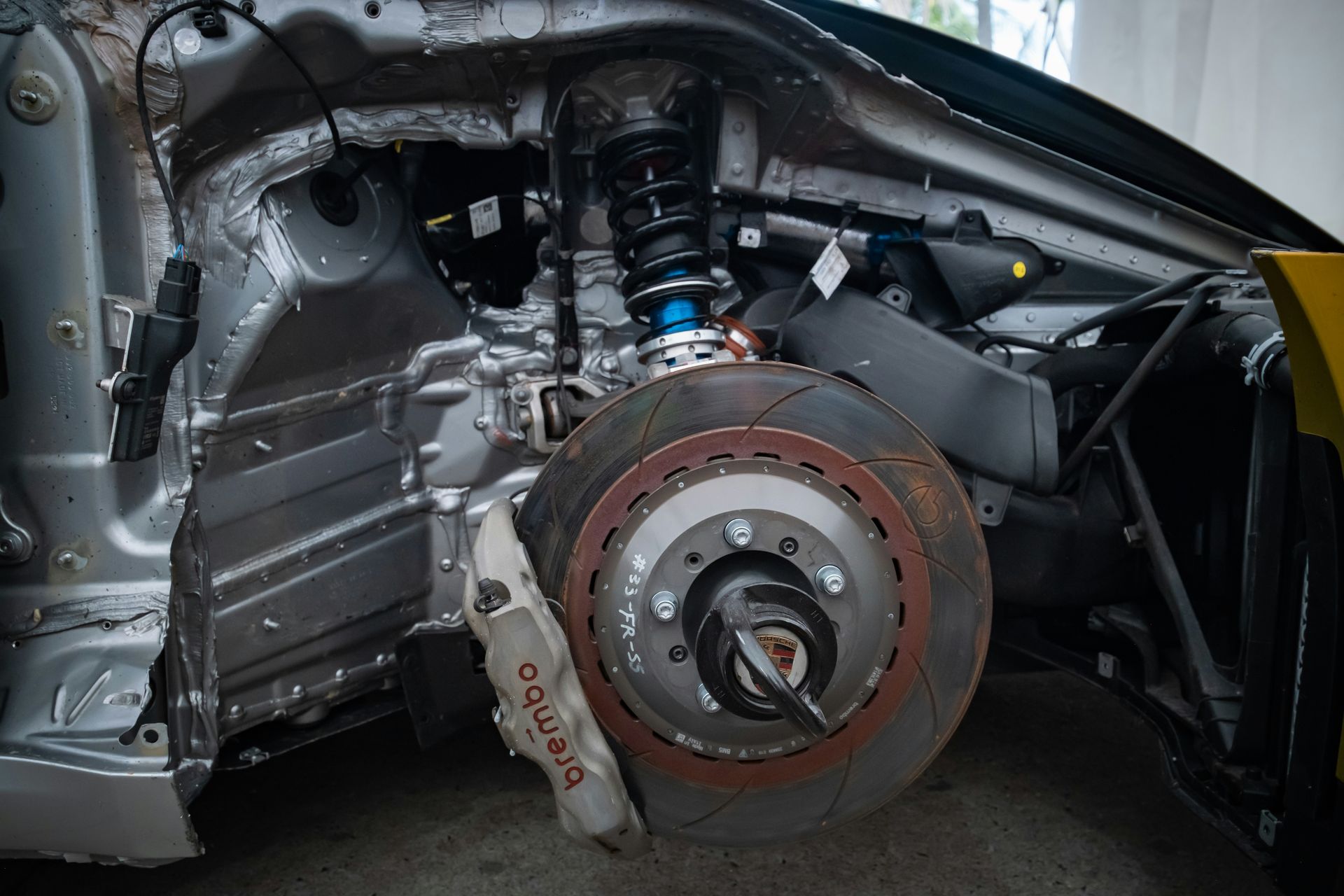 Car front suspension, brake disc, and caliper exposed